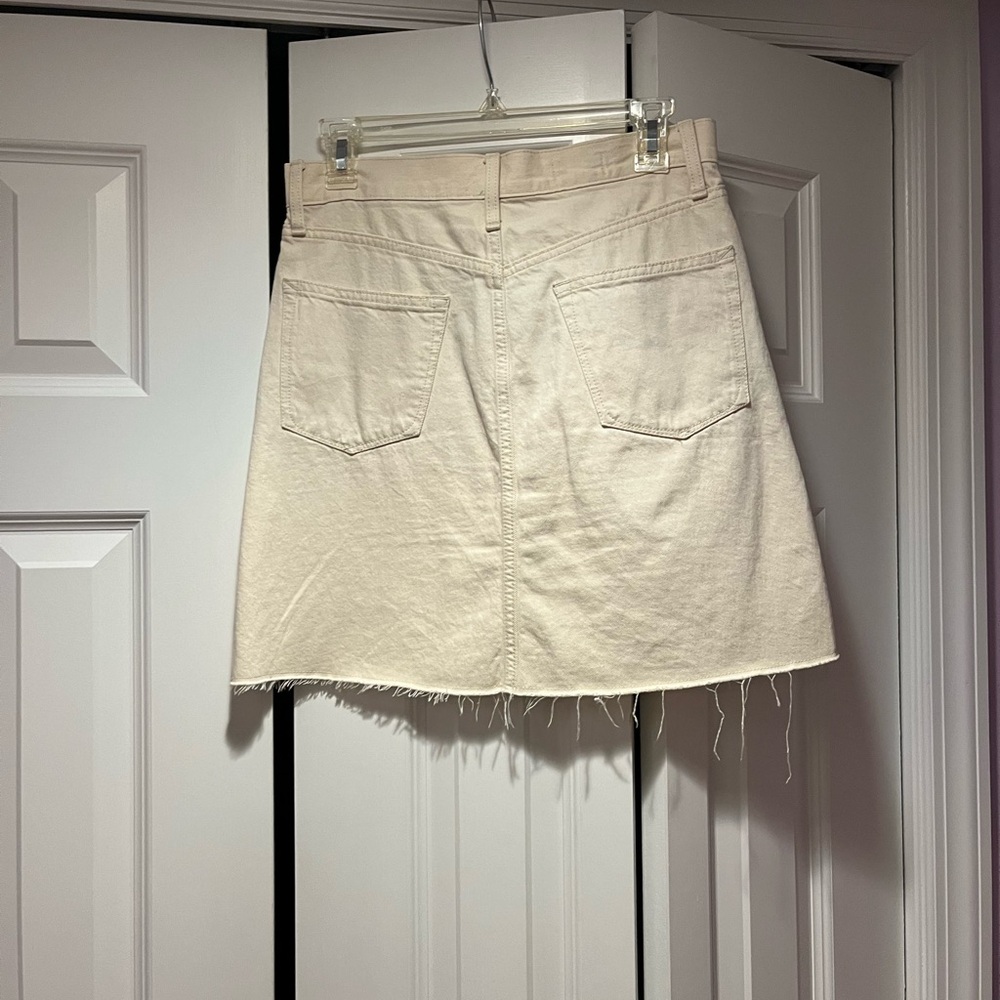 Cute mini comes above the knee. Size 27 waist very cute with back pockets